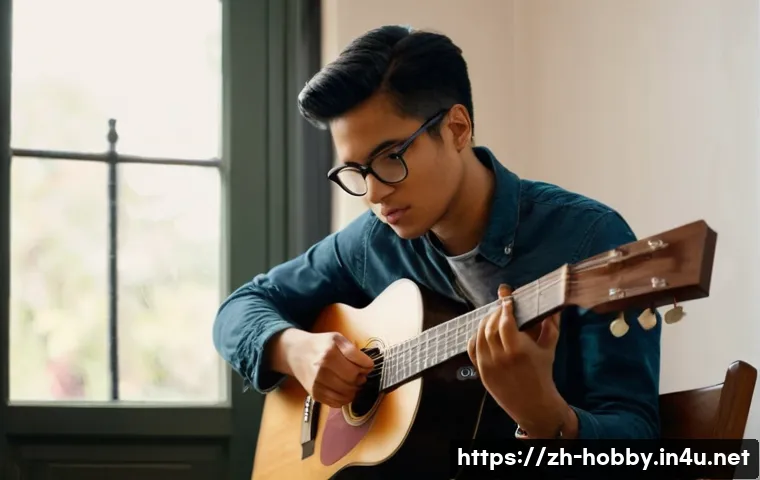 기타 배우기 - A young adult beginner guitarist practicing at home, sitting upright on a wooden chair with a slight...